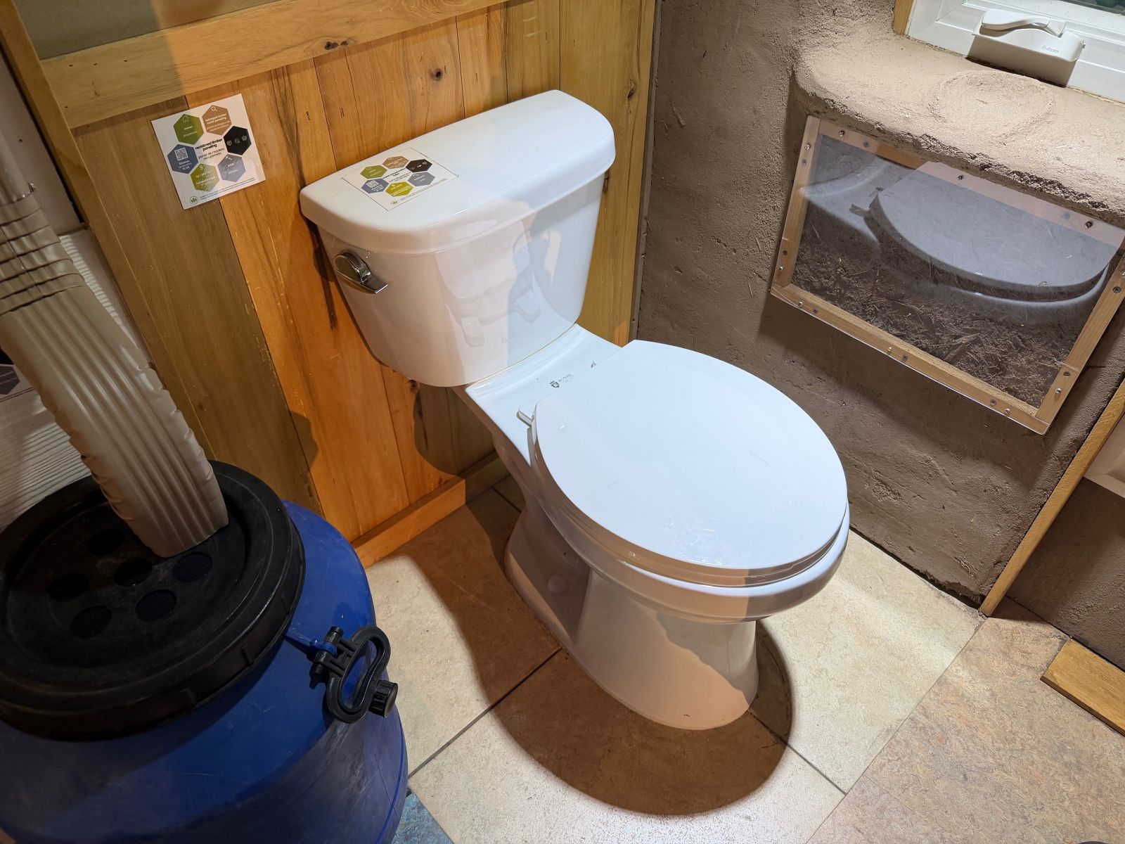 USGBC CA BuildSMART rain barrel, toilet and adobe wall 