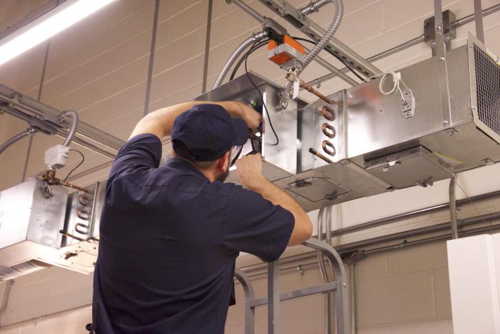 man fixing hvac